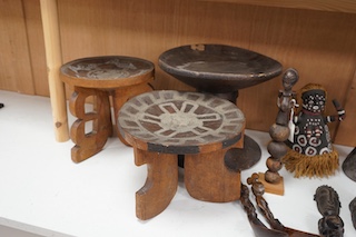 Two African tribal busts, two carved spoons and three carved Kamba Kenyan stools (11). Largest stool 28cm high. Condition - mostly good, some staining to seat of largest stool